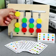 a person playing with an abacusk game on a table next to some books