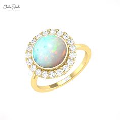 an opal and diamond ring in yellow gold with diamonds on the bottom, set against a white background