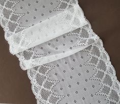 Off-white stretch lace trim with a pretty geometric design. Wide elastic lace with double flounce edges and is excellent quality with a soft handle and drape. This listing is for 1 METER = 1.09 yard width: 8.85 inch = 22.5 cm Ideal for sewing and craft projects. This stretch lace ideal for lingerie, bra making, clothing, accessories, doll dresses, table runner decoration, home textile, gifts, bags decoration, skirt bottoming, home decor and other projects you could imagine. Multiples of 1 meter White Stretch Bra With Lace Trim, White Scalloped Stretch Lace, White Stretch Scalloped Lace, White Elegant Tulle Fabric With Lace Trim, Luxury White Lace Tulle Fabric, Textile Gifts, Luxury White Tulle Fabric With Lace Trim, Lingerie Design, Delicate White Lace With Lace Trim