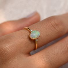 Material: 14k/18k gold orColor Options: Yellow Gold, White Gold, Rose Gold★ Center StoneOpal Oval CabochonSize: 6x8 mmApprox Weight (Ct): 0.92★ Accent StonesDiamond RoundSize: 1.5 mm * 2 No.sApprox Weight (Ct): 0.02★ Band Width: 1.3 mm★ Ring Height: 7.5 mm Opal Ring Simple, 14k Gold Opal Ring, Yellow Gold Opal Ring, Vintage Opal Engagement Ring, Delicate Gold Ring, Gold Opal Ring, Opal Band, Ethiopian Opal Ring, Opal Engagement Ring