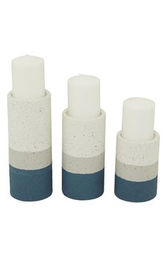 A set of cyllndrical candlesticks features a stripe pattern and speckled stone-like material to host ambient light in your home. Set of three Set includes: 10.10" x 4.0" , 8.15" x 4.05", 6.15" x 4.05" Iron Imported Metal Candle Stand, Blue Candle Holders, Striped Candles, White Candle Holders, Metal Candle Holder, Modern Candle Holders, Coloured Candles, Pillar Candle Holder, Calming Atmosphere