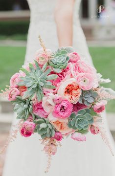 a bridal holding a bouquet of flowers and succulents