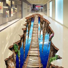 a wooden bridge that is in the middle of a floor with blue sky and clouds painted on it