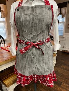 the apron is made out of an old pair of jeans and red bandannas