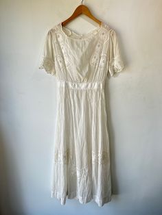 Vintage Victorian Sheer Embroidered Dress. Delicate cotton with short sleeves, waist cinch, and button down the back. In excellent vintage condition. One stain on the skirt visible in photos attached. Hand wash cold and line dry, very delicate. Best fits XS. Approximate measurements:Underarm to underarm: 16.5"Waist: 12" across laying flat.Length: 50" Summer Daywear Victorian Dress With Lace Trim, Vintage Victorian Dress With Lace Trim And Short Sleeves, Cotton Victorian Dress With Lace Trim, Vintage White Dress With Yoke Detail, Vintage White Victorian Dress With Lace Trim, Sheer Embroidered Dress, Cinched Waist, Embroidered Dress, Short Sleeves