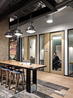 an office with wooden tables and chairs