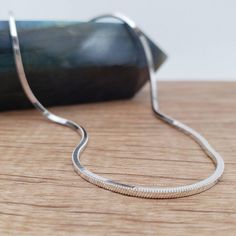 The classic snake chain is comprised of tightly woven sterling silver bands. This gives the chain a sleek, polished appearance which will maintain its curved manner while holding the weight of a pendant. This chain is then faceted into four shiny sides, adding extra sheen to the chain. Regular, rounded versions are also available - see them in our shop! - Made of solid .925 Sterling Silver (not plated) - Excellent quality, Italian-made. - Chain Width: 1.2 mm - Approximate Weights:   16" - 5.4g. Silver Snake Chain Necklace Gift, Silver Snake Chain Jewelry, Silver Delicate Snake Chain Necklace, Silver Snake Chain Necklace With Adjustable Chain, White Gold Sterling Silver Snake Chain Necklace, Silver Snake Chain Necklace With Polished Finish, Minimalist Snake Chain Necklace With Sterling Silver Clasp, Silver Nickel-free Snake Chain Necklace, Nickel-free Silver Snake Chain Necklace