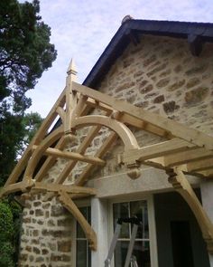 a wooden trellis on the outside of a house