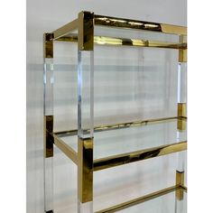 a gold and glass shelf with three shelves