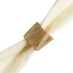 a wooden napkin holder on top of a white cloth