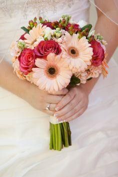 a bride holding a bouquet of flowers in her hands