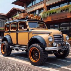 an old fashioned car parked in front of a building with orange rims and tires