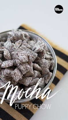 a bowl filled with puppy chow sitting on top of a table