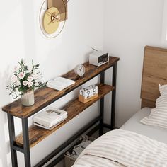 a bed room with a neatly made bed and a clock on the wall above it