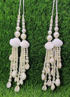 Indian Handmade White Pearl Latkan for Saree Blouse Lehenga HandBags Dupatta Decoration Bridal Wedding dress for Women pair of 2 pcs Size - 22.0 cm Length  Item Description You can use this Beautiful pair of tassle for several DIY projects.  *These beautiful Tassel Latkans are used as the accessory for saree blouse on the back, but u can use according to your need and your innovative ideas. * Package contains 2 Latkan / 1 Pair Other Than Saree Blouse, you can use these latkans in various ways Craft Projects Designing Home Decoration Festive celebrations. Evening and party Apparels. Home décor items Apparel & Fashion Scarves n Stoles Headband, hats Table cover, curtains, Pillow covers, Cushion cover Shoe designing Headband, hats Table cover, curtains Designing stylish blouses Ship From New Latkan Tassels Lehenga, Luxury Traditional Wear With Latkans, Diy Latkan For Lehenga, Luxury Saree With Latkans For Festivals, Luxury Chandbalis With Latkans As A Gift, Latkan Tassels Blouses Accessories, Luxury Chandbalis With Latkans For Women, Luxury Latkans Danglers For Reception, New Latkan Designs