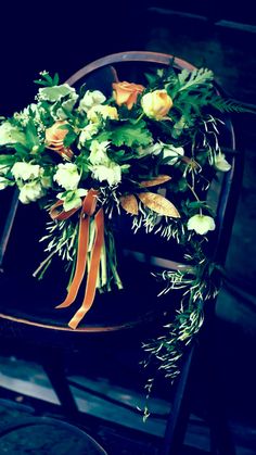 a bouquet of flowers sitting on top of a chair