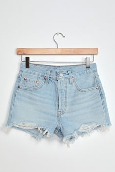 The Levi's 501 Light Blue High-Rise Denim Cutoff Shorts are what denim dreams are made of! Sturdy non-stretch light blue denim (in Levi's Luxor Heat wash) boasts light distressing and fading throughout as it shapes these classic cutoffs with a high-waisted fit, belt loops, a branded top button, hidden button fly, and five-pocket cut. Raw hems. Brown leather logo patch and iconic red logo tag at back. Fit: This garment fits true to size. Length: Above mid-thigh. Size 27 Inseam: 2.50 Front Rise: 1 Levi's Light Wash Relaxed Fit Jean Shorts, Light Indigo Summer Jeans, Levi's Light Wash Jean Shorts For Spring, Trendy Light Indigo Bottoms For Summer, Light Blue Short Jeans For Summer, Light Blue Short Length Jeans For Summer, Light Wash Fitted Cutoff Bottoms, Levi's Light Wash Denim Jean Shorts, Levi's Relaxed Fit Light Wash Shorts