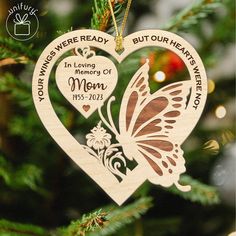 a wooden ornament shaped like a heart with a butterfly on it and the words in loving memory of mom