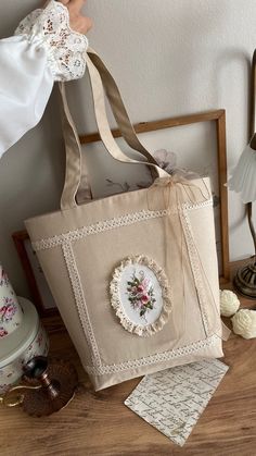 a handbag sitting on top of a wooden table next to a white doily