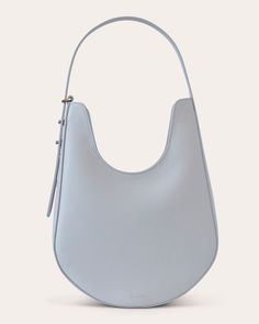 Defined by its smooth curves and balanced proportions, S.Joon's Lunar bag pairs its calf leather body with a lined, pocketed interior. Adjustable with silvertone pin hardware, the strap can be carried by hand or slung over the shoulder. Adjustable strap Zip closure Interior slip pocket Silvertone hardware Outer: 100% calf leather Lining: 100% suede Spot clean Made in Italy Measurements Width: 9.44in Height: 11.81in Depth: 2.75in Sustainability Metrics: Natural Resources: at least 50% of materials used are produced with a reduced environmental impact Read more about Olivela's sustainability pillars here. Timeless Shoulder Bag With Silver-tone Hardware, Classic Shoulder Bag With Silver-tone Hardware For Everyday, Classic Leather Hobo Bag With Silver-tone Hardware, Classic Formal Hobo Bag With Palladium Hardware, Timeless Hobo Bag With Palladium Hardware, Classic Hobo Bag With Silver-tone Hardware For Everyday Use, Classic Hobo Bag With Silver-tone Hardware And Double Handle, Classic Formal Hobo Bag With Silver-tone Hardware, Chic Hobo Bag With Palladium Hardware For Daily Use