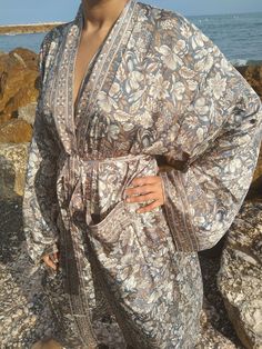 Our super soft robes are made from a Sari; which is traditional Indian garment. A long piece of fabric draped elegantly around the body.  It can be used like a luxurious robe to feel pampered in at home or even as a kimono or cover up on your day out. For sure you will feel like a super star.  Our robes are unisex,gender free garments for all body types. Yes! We all deserve to feel special and classy.  The sleeves are long and voluminous. Length of garment is approx 55 inches.  Washing instructions: Machine wash in Cold water. No hot water and No dryer.Regular Iron.  Fabric: Silk and viscose blend Bohemian Open Front Robe For Loungewear, Bohemian Open Front Loungewear Robe, Bohemian Floral Print Robe For Loungewear, Bohemian Wrap Robe For Home, Bohemian Long Sleeve Robe For Home, Bohemian Style Home Robe, Summer Relaxation Kimono With Kimono Sleeves, Luxury Kimono, Postpartum Gift