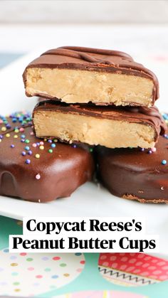 three chocolate covered donuts stacked on top of each other