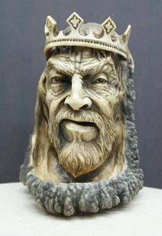 a statue of an old man with a crown on his head