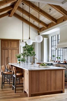 a large kitchen with wooden cabinets and an island