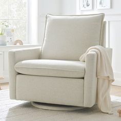 a living room with a white chair and rug