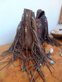 Native American inspired Handmade Leather Fringed Crossbody Bag.. Dark vintage brown Leather. Crossbody or Shoulder Bag depend your mood !! Beautiful Ethnic Handbag with Fringes and Beads. Painted with Native American Symbols-Desings- embroidered with nice colors! Both side of the Bag are Fringed and decoraded with beads-(you can ad your personal charms if you want). I enjoy every moment creating this exceptional Bag. Become better with hard use.Will take beautiful shades when aging. I wish that Bohemian Brown Shoulder Bag For Festival, Bohemian Brown Shoulder Bag, Hippie Handmade Brown Shoulder Bag, Brown Artisan Shoulder Bag For Festivals, Hippie Brown Handmade Shoulder Bag, Handmade Bohemian Leather Shoulder Bag, Bohemian Leather Shoulder Bag With Hand-stitched Details, Bohemian Brown Hand-tooled Shoulder Bag, Brown Leather Hobo Bag For Festival