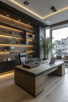 an office with wooden flooring and built in shelving units on either side of the window