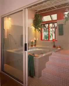 an indoor jacuzzi tub in the middle of a room with tiled floors and walls