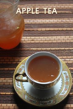 a cup of tea sitting on top of a saucer next to a jar of liquid