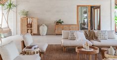 a living room filled with lots of white furniture