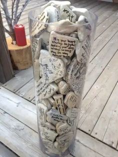 a vase filled with lots of rocks on top of a wooden deck