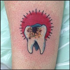 a tooth with an insect on it and sunbursts around the teeth tattoo