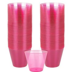 pink plastic cups are stacked on top of each other with one cup in the middle