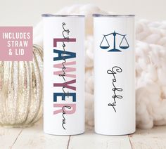 two personalized tumbles with the words law and justice on them next to a ball of yarn