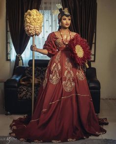 a woman in a red dress holding a large flower