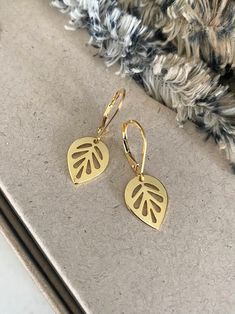 "These 24k gold plated leaf dangle earrings exude elegance with their delicate design, making them perfect for everyday wear. The earrings are finished with gold filled lever backs for a secure wear.  Their subtle shimmer adds a touch of sophistication to any outfit, effortlessly elevating your style. Crafted with attention to detail, they offer a timeless appeal that seamlessly transitions from day to night, ensuring you feel refined and chic at all times.  Also available in rhodium plated finished with sterling silver lever backs. The earrings measure just over 1\" from end to end.  The leaf charms are approx 14x11mm. You may also like to check out more of my earrings here: http://etsy.me/2e2BGZl Free first class USPS domestic USA shipping" Yellow Gold Leaf-shaped Earrings For Pierced Ears, Yellow Gold Leaf Earrings, Gold Leaf-shaped Nickel-free Earrings, Everyday Gold Leaf-shaped Jewelry, Everyday Gold Leaf Jewelry, Gold Delicate Hypoallergenic Teardrop Earrings, Gold-plated Leaf-shaped Earrings, Gold Leaf-shaped Single Earring, Gold Single Leaf-shaped Earring