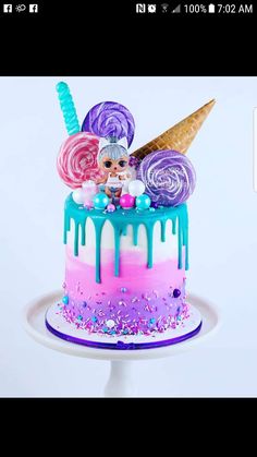 a cake decorated with candy, lollipops and an ice cream cone on top