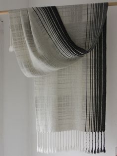 a black and white striped scarf hanging on a wall