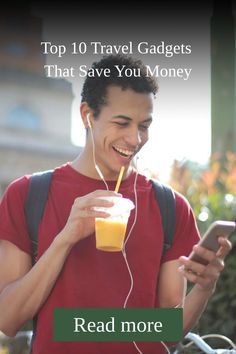 a man holding a drink and listening to headphones while looking at his cell phone