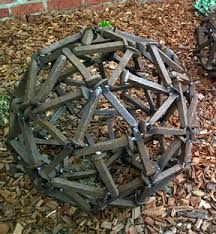 two wooden balls sitting on top of some wood chips