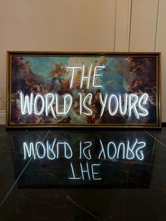 a neon sign that says the world is yours