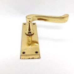 an antique brass door handle on a white background