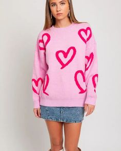 Embrace warmth and whimsy with our Long Sleeve Round Neck Heart Printed Sweater. This charming knit features an adorable heart pattern, adding a playful and romantic touch to your winter wardrobe. The round neck and long sleeves provide a classic silhouette, ensuring both comfort and style. Model is wearing a smallModel SpecsHeight: 5'8"Bust: 32A Waist: 24"Hips: 34" Style: Casual Print / Pattern: Heart Silhouette: Sweater Fit: Regular Embellishment: Heart Printed Neck Line: Round Sleeve: Long Sl Pink Long Sleeve Sweatshirt With Heart Graphic, Pink Heart Print Sweater For Valentine's Day, Cotton Sweatshirt With Heart Graphic, Long Sleeve, Pink Heart-shaped Valentine's Day Sweater, Red Heart-shaped Valentine's Day Sweater, Sweater Fits, Shoes With Jeans, Printed Sweater, Pink Sweater