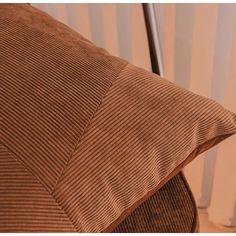 a brown pillow sitting on top of a wooden chair