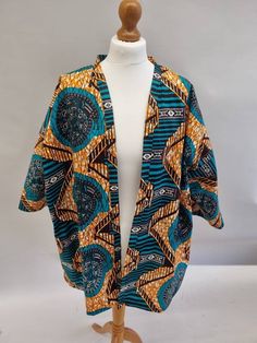 Beautiful kimono style short jacket made from African print material.  Can comfortably fit sizes 10-16. 100% cotton. Cool handwash to help keep shape. With pockets. To view my full range please visit bykalax.etsy.com. Multicolor Printed Outerwear With Kimono Sleeves, Casual Blue Cotton Kimono, Cotton Batik Print Kimono For Spring, Multicolor Cotton Outerwear With Kimono Sleeves, Spring Cotton Kimono With Batik Print, Casual Cotton Kimono With Relaxed Fit, Multicolor Cotton Outerwear For Summer, Multicolor Cotton Open Front Outerwear, Cotton Open Front Kimono For Fall