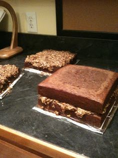 three square pieces of cake sitting on top of a counter next to a lamp and mirror